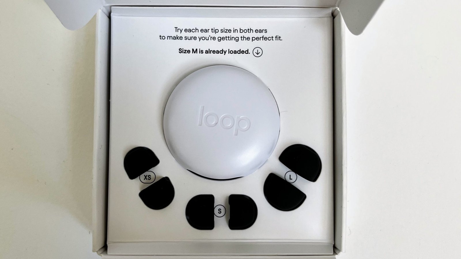 Loop Quiet 2 packaging opened to show the origami-style cardboard box, tip size card, and round carrying case inside.