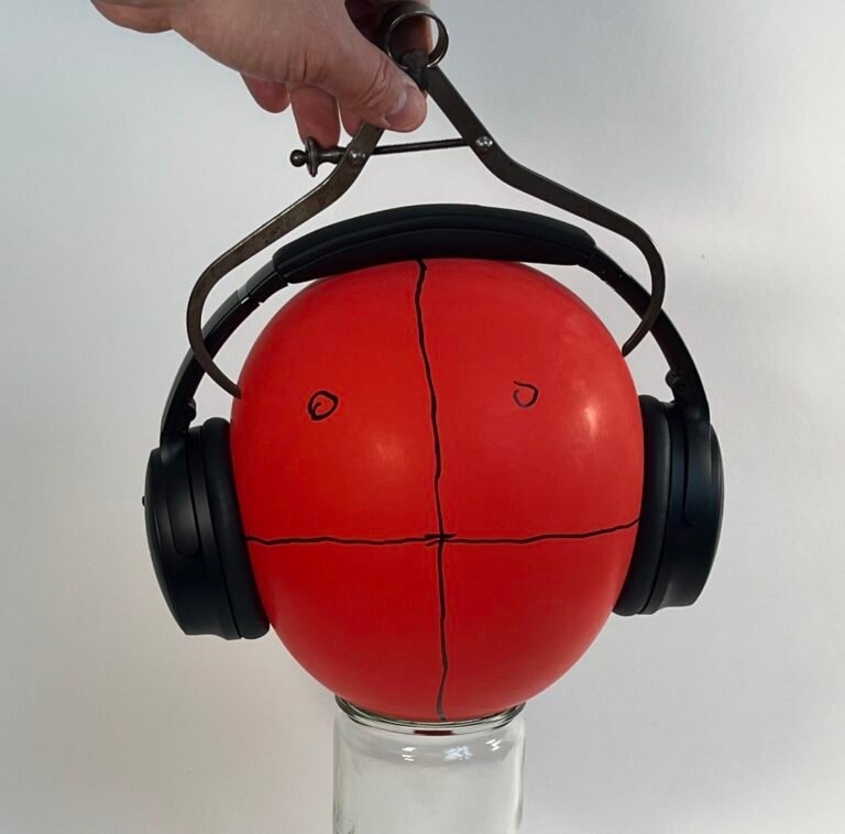 measuring a balloon with calipers
