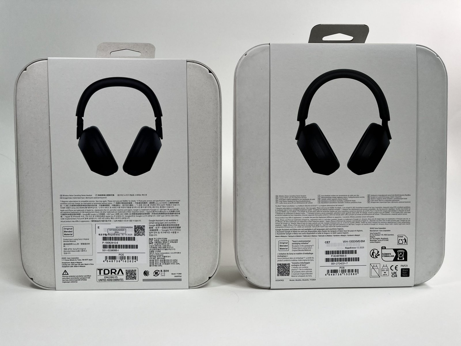 Sony XM6 and XM5 boxes from the back, showing each model's noise cancelling marketing claims